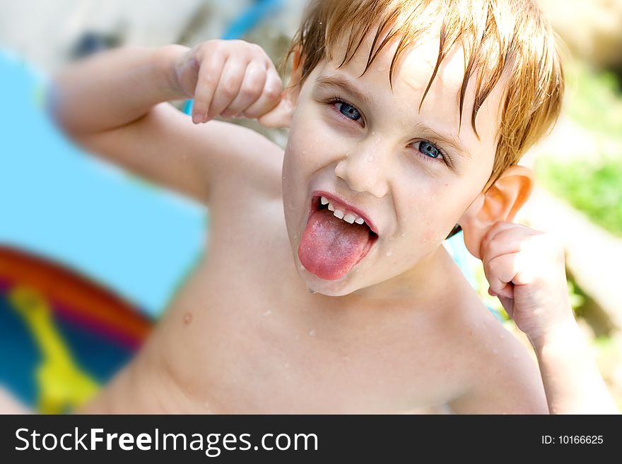 The boy bathes in inflatable pool