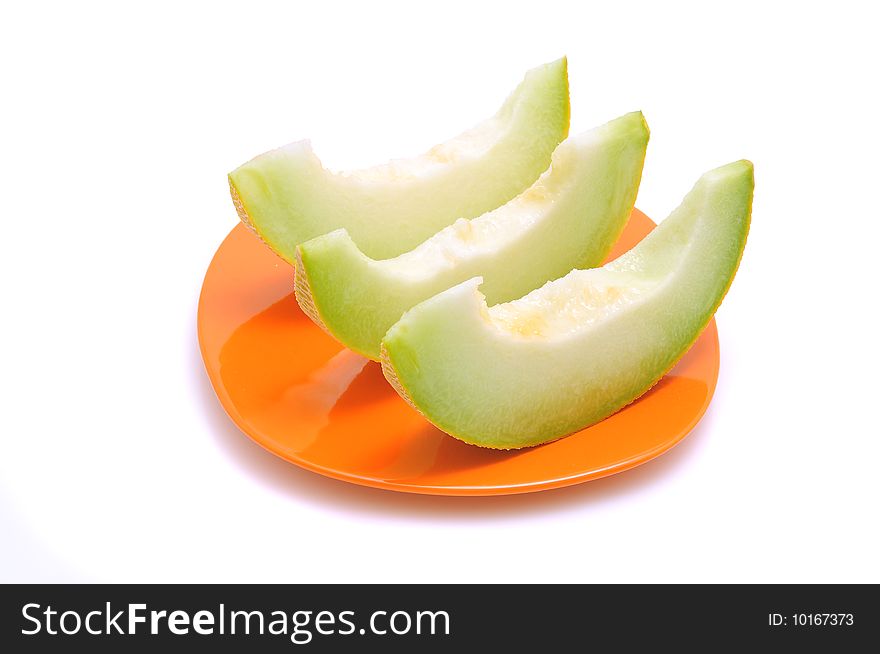 Juicy sliced melon on plate, isolated on white background.