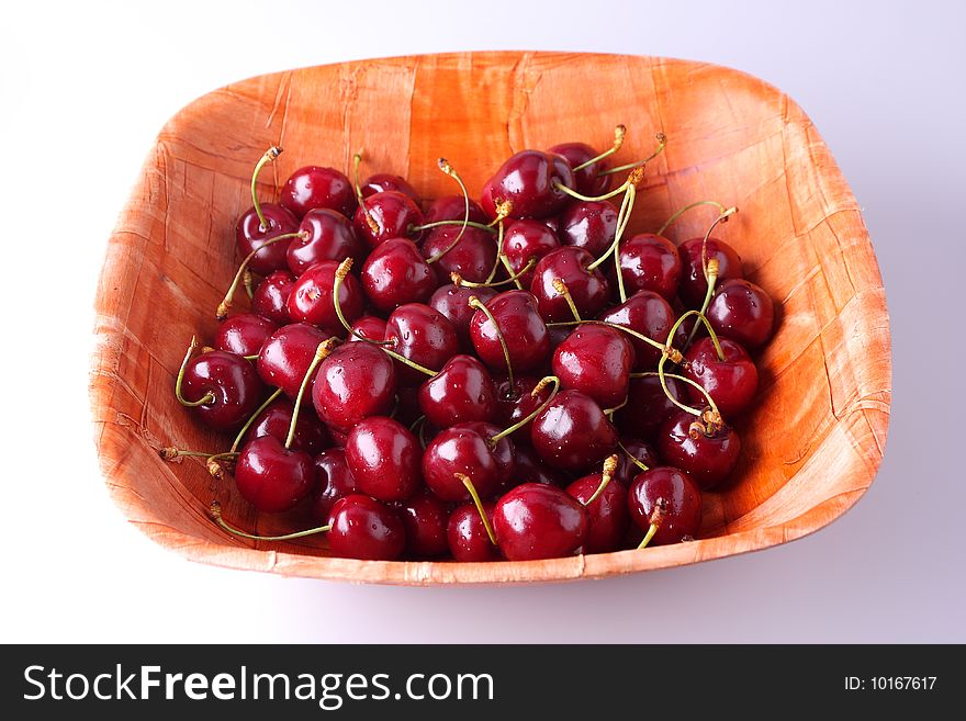 Fresh ripe cherries isolated in bamboo bowl. Fresh ripe cherries isolated in bamboo bowl