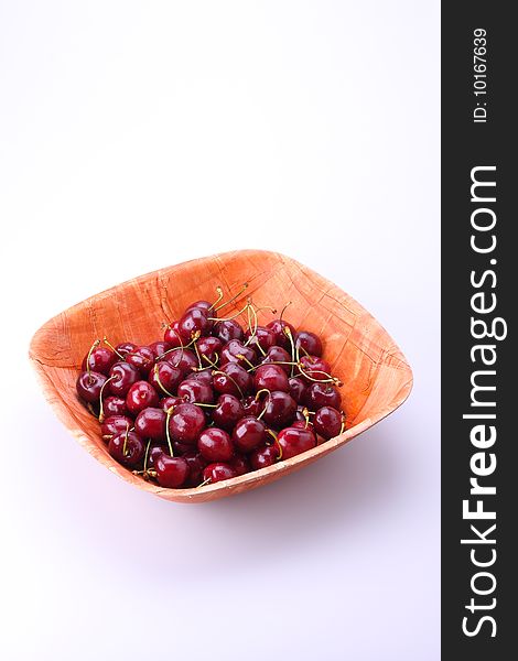 Fresh ripe cherries isolated in bamboo bowl. Fresh ripe cherries isolated in bamboo bowl