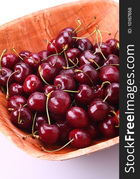 Fresh ripe cherries isolated in bamboo bowl. Fresh ripe cherries isolated in bamboo bowl