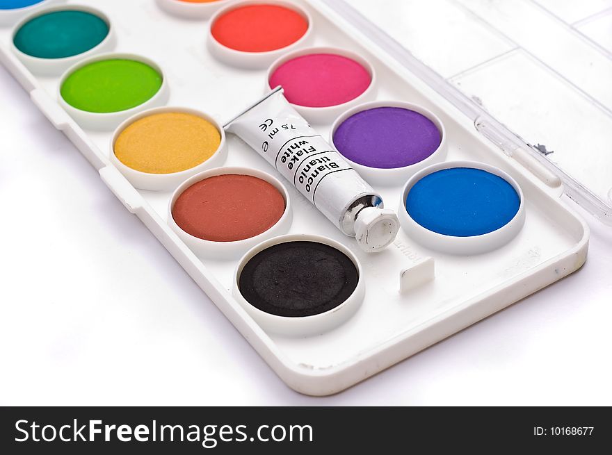 A box full of colorful gouache isolated on white