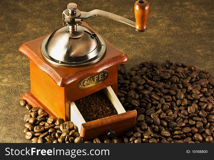 Is on the coffee grinders and coffee beans brown background