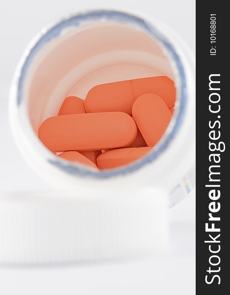 Orange capsules isolated on white