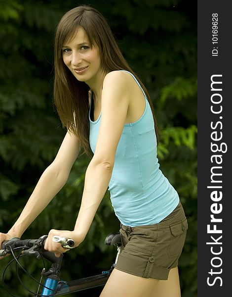Active woman with a bike posing outdoor. Active woman with a bike posing outdoor