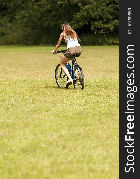 Active woman sat on a bike outdoors. Active woman sat on a bike outdoors