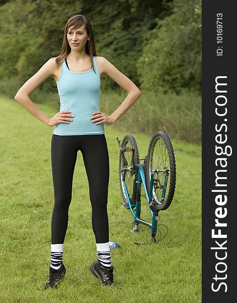 Fitness woman with a bike doing sport exercises