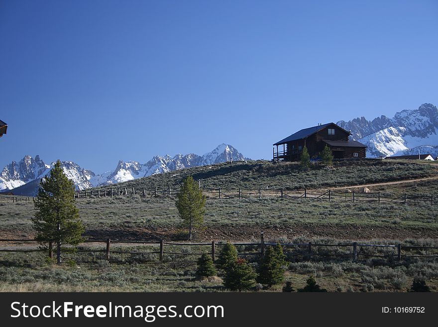 Image of a log home silloetted against the Idaho Sawtooth mountains. Image of a log home silloetted against the Idaho Sawtooth mountains.