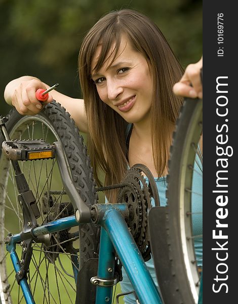 Woman repairing the bike outdoor