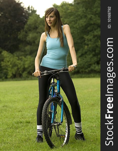 Fitness woman with a bike posing outdoor. Fitness woman with a bike posing outdoor