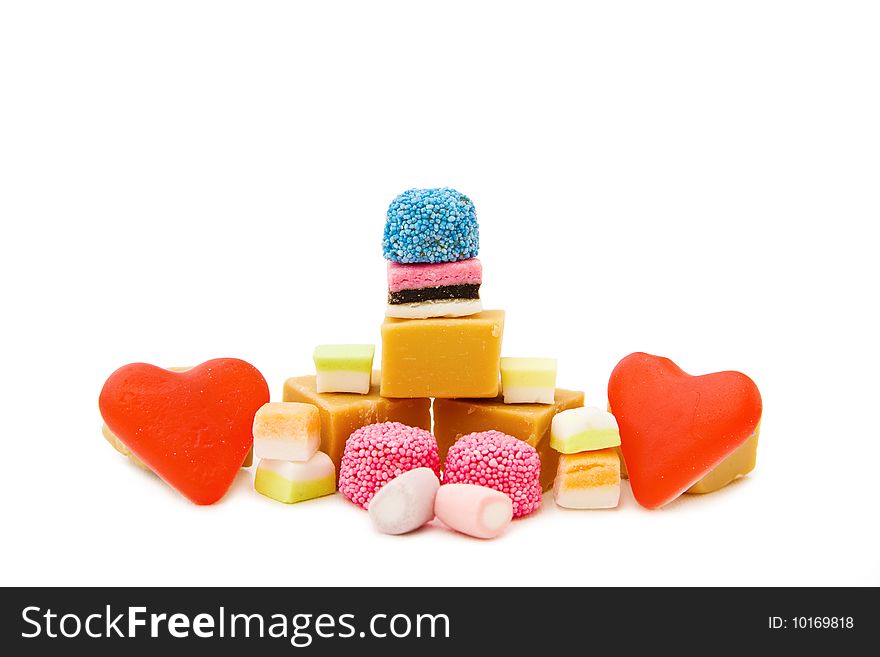 Sweets heaven - mix of caramel fudge, jelly hearts, marshmallow and colorful candy isolated on white. This image is exclusive to DT. Sweets heaven - mix of caramel fudge, jelly hearts, marshmallow and colorful candy isolated on white. This image is exclusive to DT.