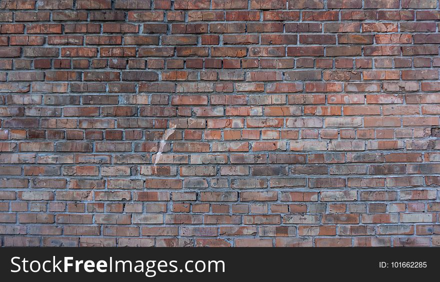 Texture of the collapsing wall of red brick burnt over time. Texture of the collapsing wall of red brick burnt over time