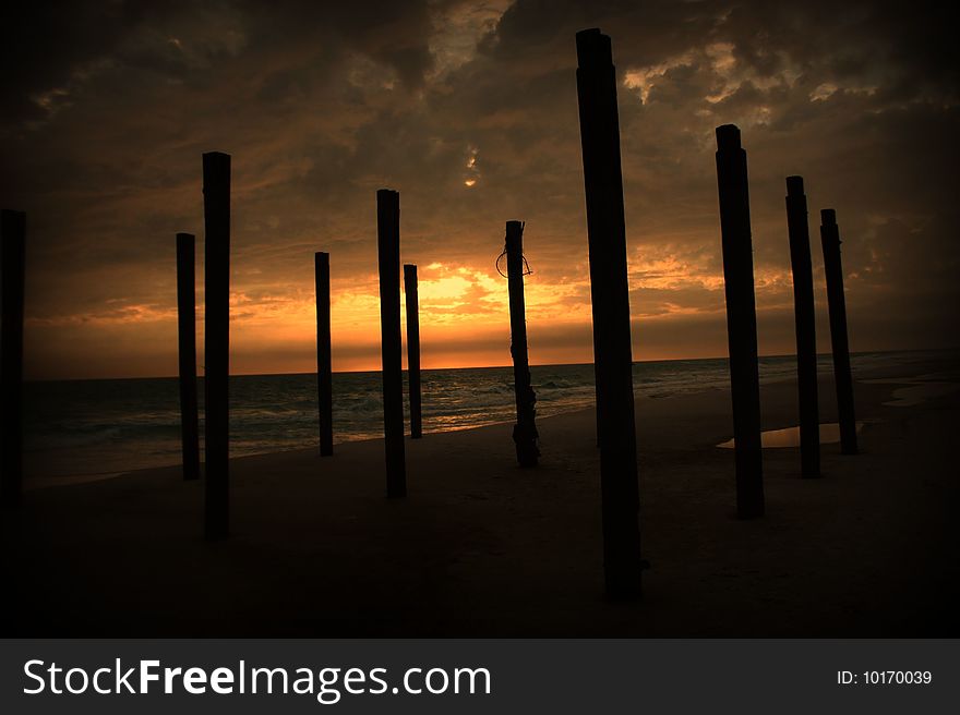 Remainder of a pier at the beach. Remainder of a pier at the beach.