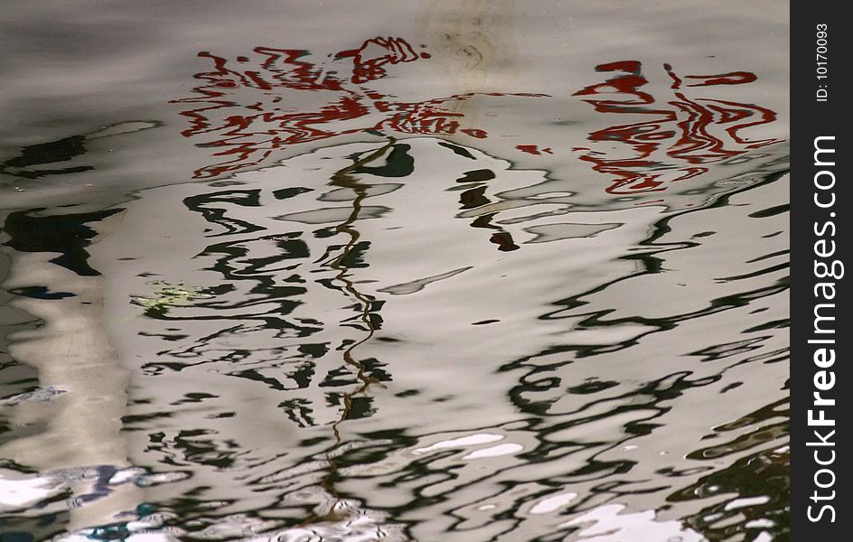 Fishing boat reflections in water