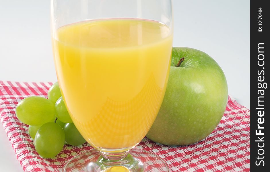 Glass of orange juice and green apple. Glass of orange juice and green apple
