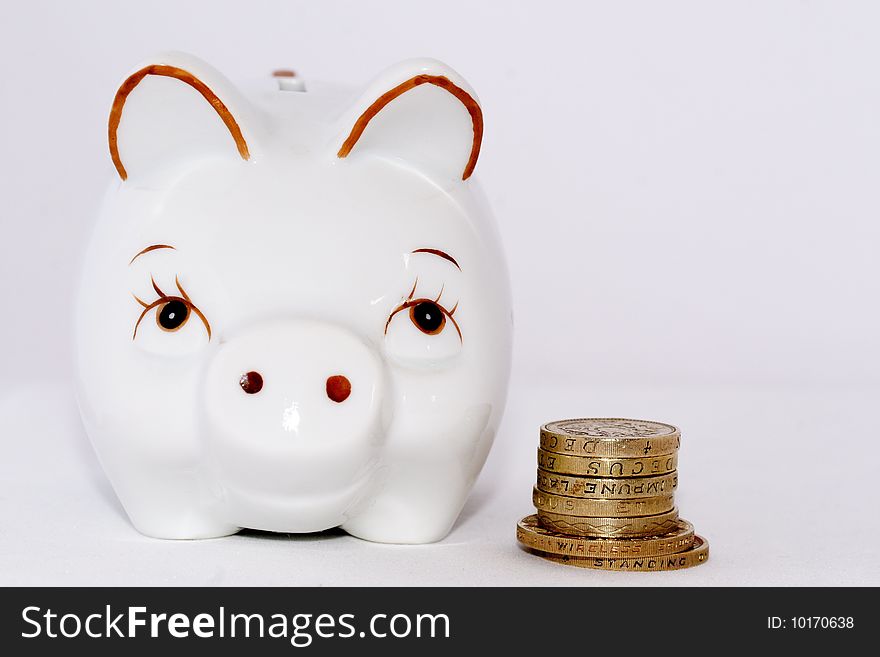 Some English coins with a piggy bank