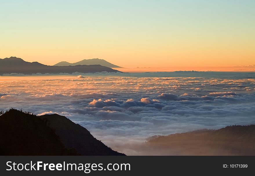 Clouds cover crater valley in early morning, Java Island, Indonesia