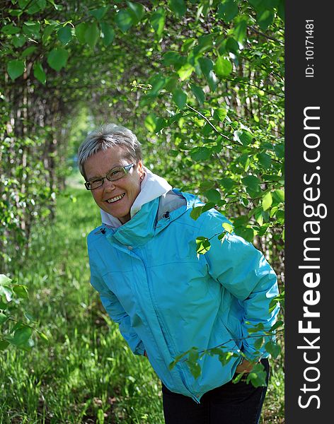 Woman peeking around a birch tree. Woman peeking around a birch tree