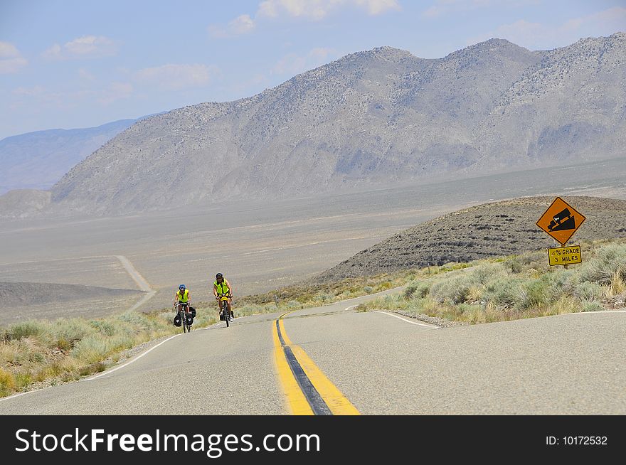 Couple Of Cyclist On Desert Road