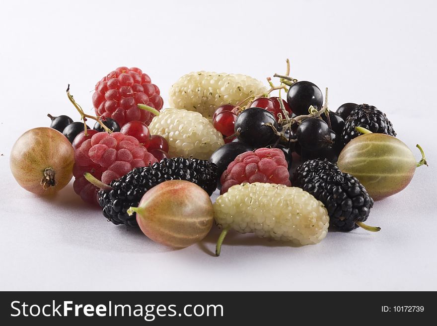 Raspberries, red currant, black currant, black mulberries, white mulberries, and gooseberry on a white background. Raspberries, red currant, black currant, black mulberries, white mulberries, and gooseberry on a white background.