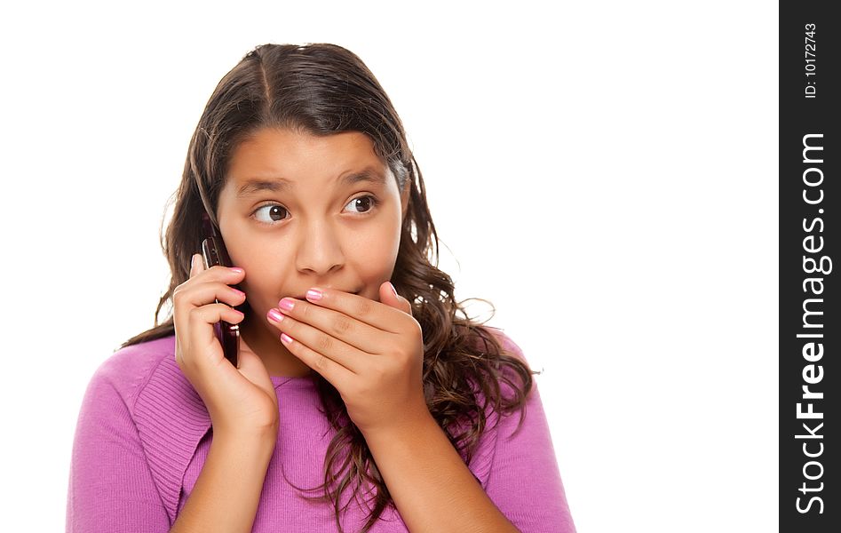 Shocked Pretty Hispanic Girl On Cell Phone Isolated on a White Background.