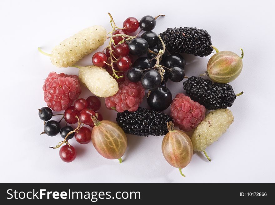 Raspberries, red currant, black currant, black mulberries, white mulberries, and gooseberry on a white background. Raspberries, red currant, black currant, black mulberries, white mulberries, and gooseberry on a white background.