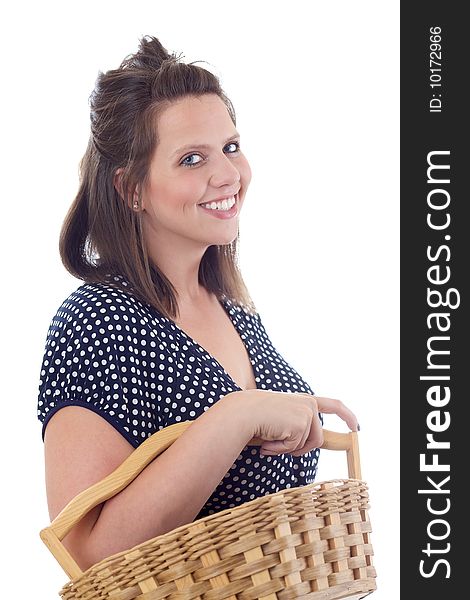 Young woman in a dress carrying a wicker basket; isolated on a white background. Young woman in a dress carrying a wicker basket; isolated on a white background.