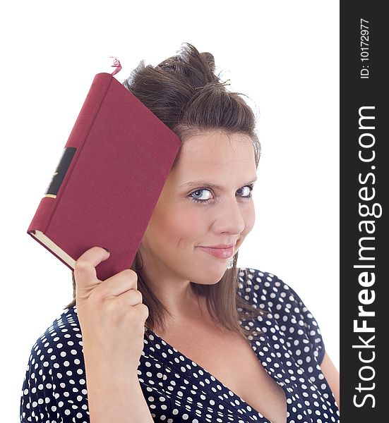 Young woman in dress holding a book to her head; isolated on a white background. Young woman in dress holding a book to her head; isolated on a white background.