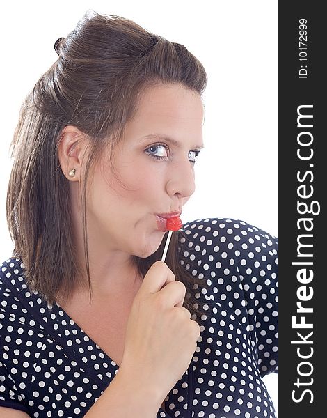 Young woman flirting holding a lollipop to her lips; isolated on a white background. Young woman flirting holding a lollipop to her lips; isolated on a white background.