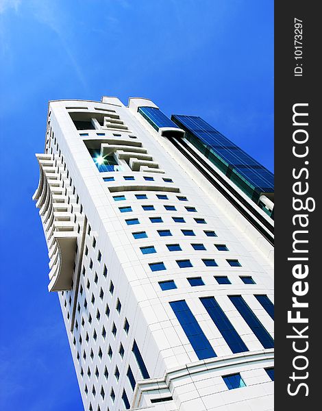 Perspective view of a blue glass skyscraper over blue sky. Perspective view of a blue glass skyscraper over blue sky.