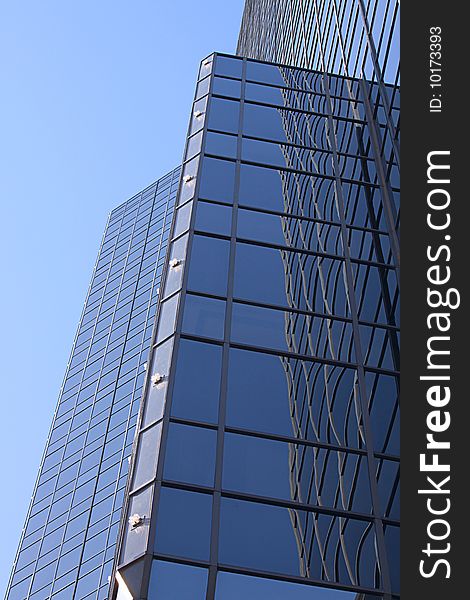 A vertical reflective skyscraper panorama.