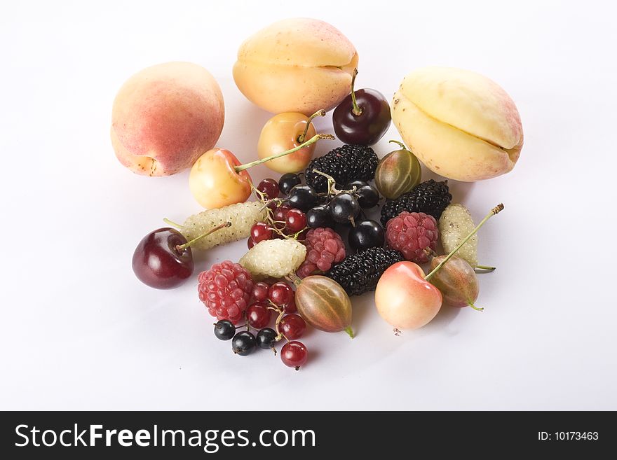 Raspberries, red currant, black currant, black mulberries, white mulberries, apricots, cherries and gooseberry on a white background. close up. Raspberries, red currant, black currant, black mulberries, white mulberries, apricots, cherries and gooseberry on a white background. close up