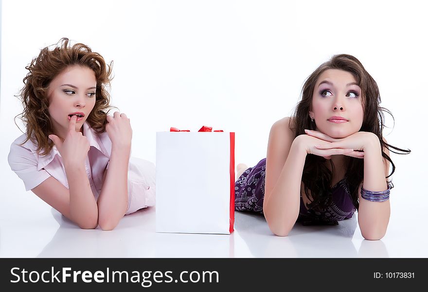 Two young women with shopping bag in different actions and emotions. Two young women with shopping bag in different actions and emotions