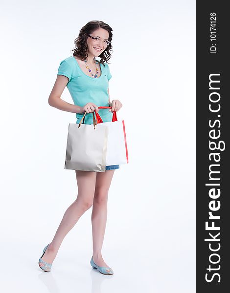 Young woman with shopping bags smiling. Young woman with shopping bags smiling