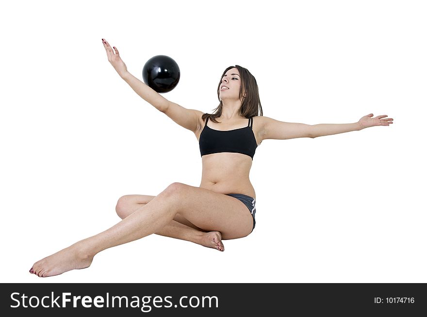 Young girl balancing with black ball