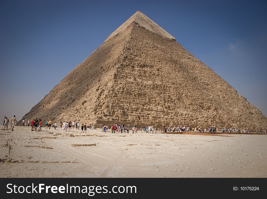 The Pyramid of Khafrae is the second largest of the Ancient Egyptian Pyramids of Giza and the tomb of the fourth-dynasty pharaoh Khafre (Chephren in Greek), The pyramid has a base length of 215.25 m (706 ft) and originally rises to a height of 143.5 m (471 ft). The Pyramid is made of Limestone blocks (weighing more than 2 tons each). The slope of the pyramid rises at an 53ï¿½ 10' angle, steeper than