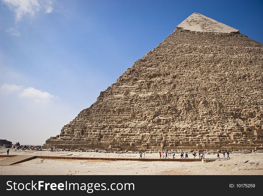 The Pyramid of Khafrae is the second largest of the Ancient Egyptian Pyramids of Giza and the tomb of the fourth-dynasty pharaoh Khafre (Chephren in Greek), The pyramid has a base length of 215.25 m (706 ft) and originally rises to a height of 143.5 m (471 ft). The Pyramid is made of Limestone blocks (weighing more than 2 tons each). The slope of the pyramid rises at an 53ï¿½ 10' angle, steeper than