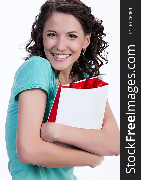 Young woman holding a bag and smiling. Young woman holding a bag and smiling