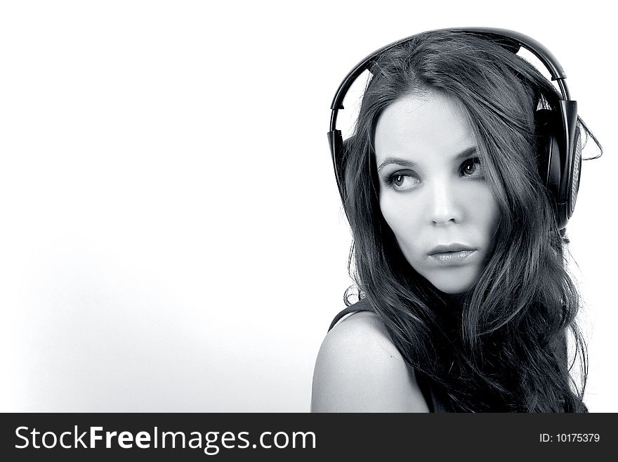 Young dj girl with headphones on white background in monochrome. Young dj girl with headphones on white background in monochrome