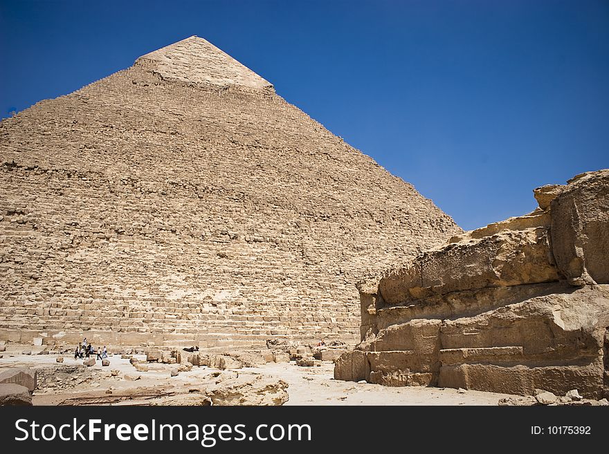 The Pyramid of Khafrae is the second largest of the Ancient Egyptian Pyramids of Giza and the tomb of the fourth-dynasty pharaoh Khafre (Chephren in Greek), The pyramid has a base length of 215.25 m (706 ft) and originally rises to a height of 143.5 m (471 ft). The Pyramid is made of Limestone blocks (weighing more than 2 tons each). The slope of the pyramid rises at an 53� 10' angle, steeper than