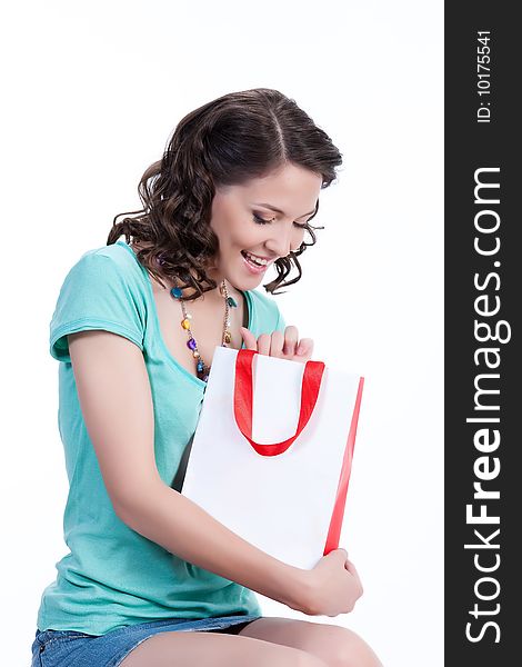 Young woman holding a bag and smiling. Young woman holding a bag and smiling