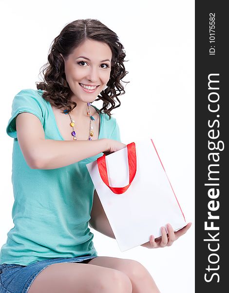 Young woman holding a bag and smiling. Young woman holding a bag and smiling