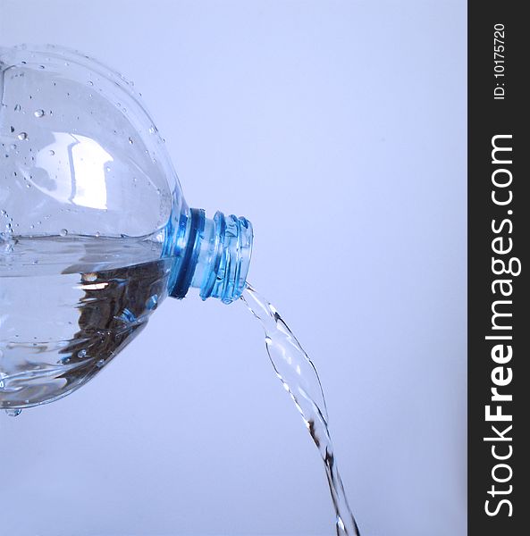 Close up view of Water going out of a plastic bottle. Close up view of Water going out of a plastic bottle