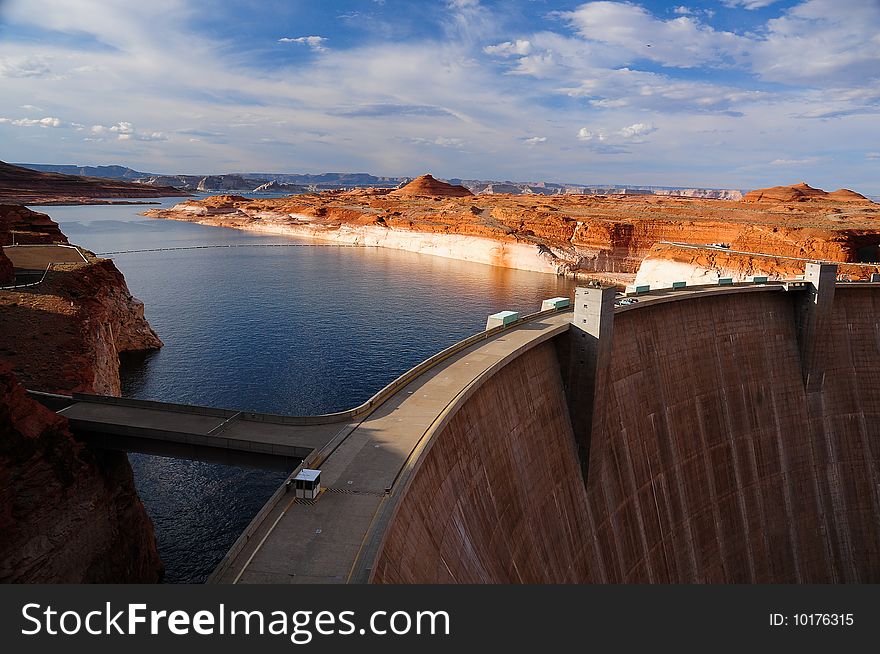 A picturesque view of the curving wall of the Glen Canyon Dam on the Colorado river in Arizona, USA. A picturesque view of the curving wall of the Glen Canyon Dam on the Colorado river in Arizona, USA.