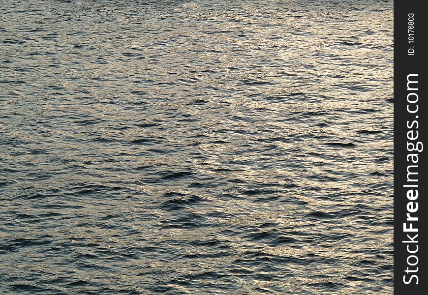 Water surface illuminated by the setting sun