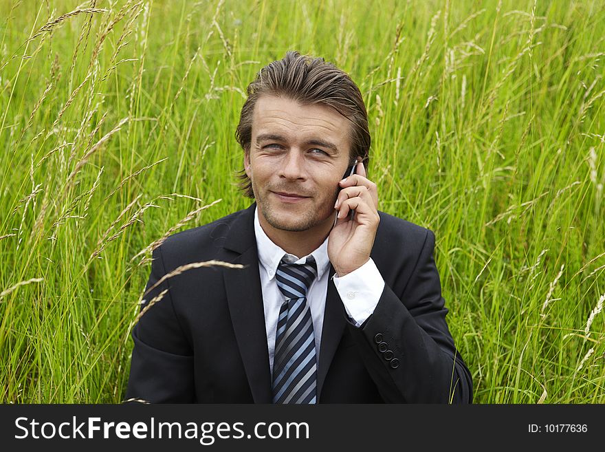 Well-dressed young businessmann is on the phone