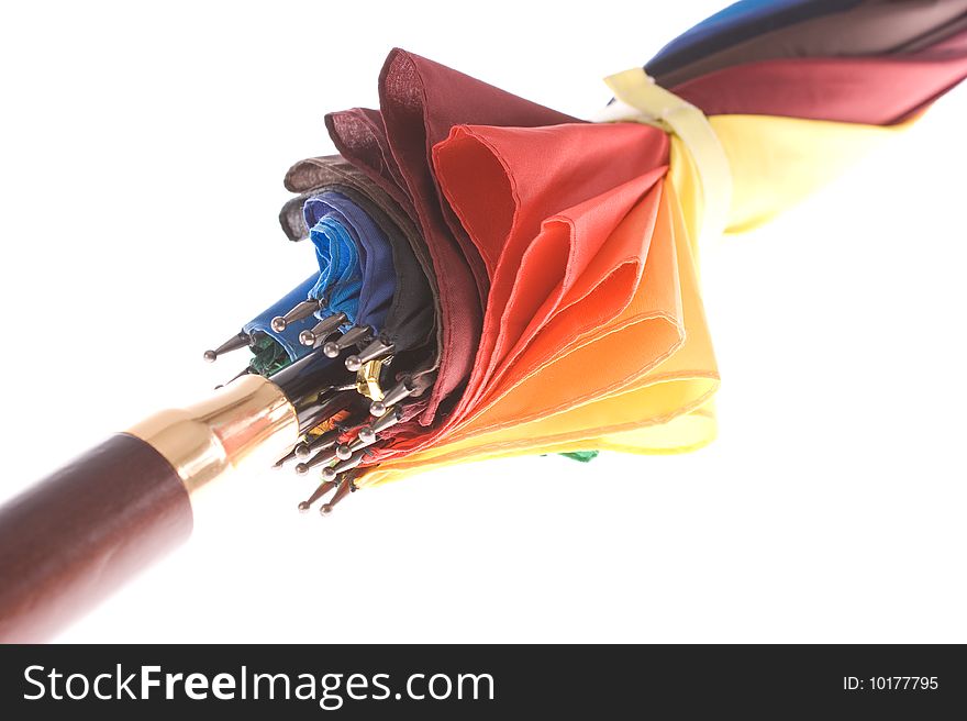 Rainbow colored umbrella on white background