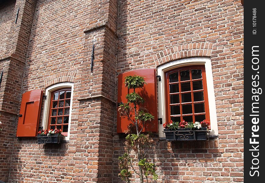 2 windows in a brick wall