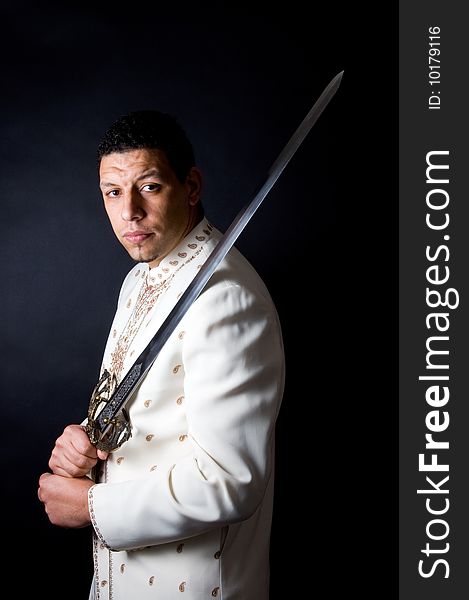 Aruban algerian man with sword posing on black background