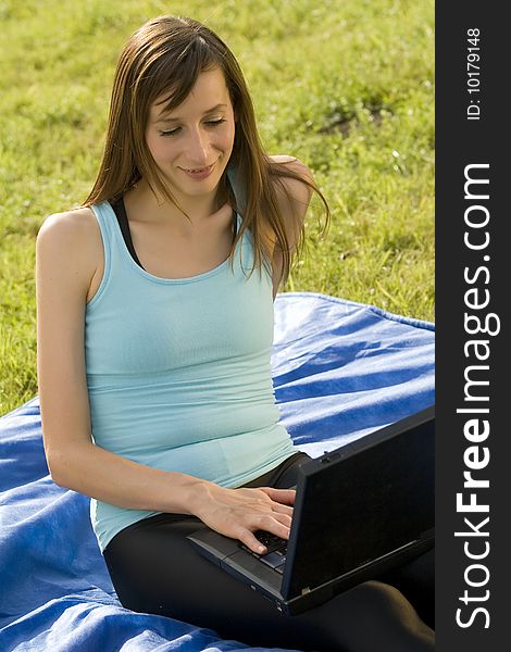 Female student with a laptop working outdoor. Female student with a laptop working outdoor